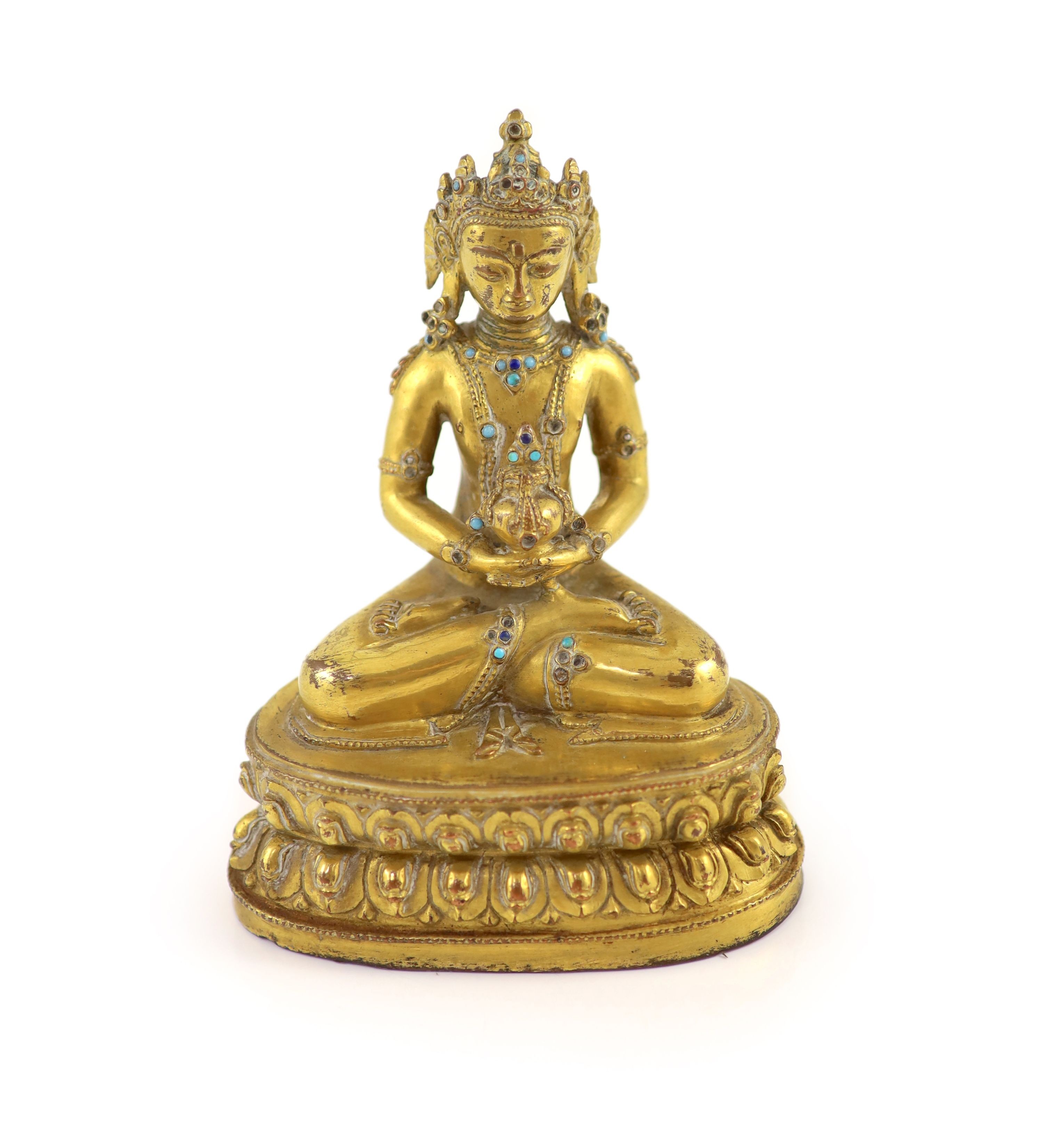 A Tibetan gilt copper alloy seated figure of Amitayus, probably 15th/16th century, 15cm high